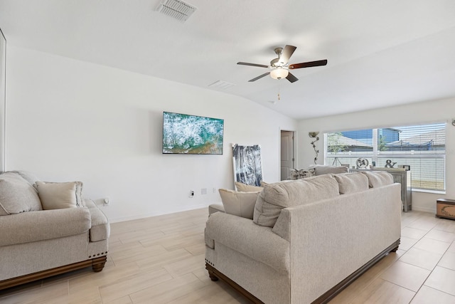 living area featuring vaulted ceiling, visible vents, baseboards, and a ceiling fan