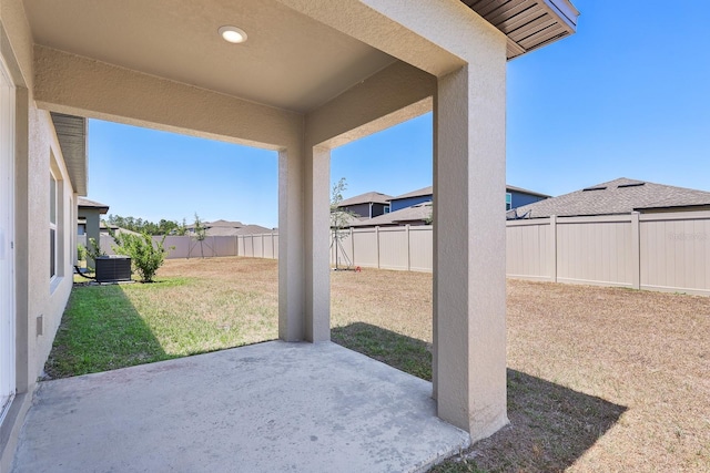 view of patio with a fenced backyard and central AC unit