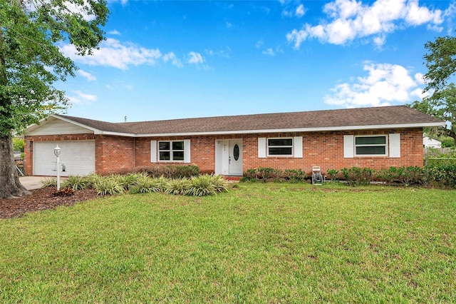 424 Forest Glen Ave, Lakeland, FL 33813 - ranch-style house featuring a garage, brick siding, a front yard, and concrete driveway