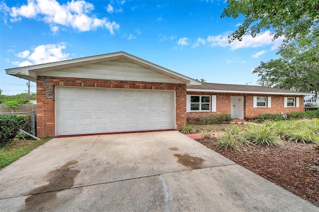 424 Forest Glen Ave, Lakeland, FL 33813 - ranch-style home with brick siding, concrete driveway, and an attached garage