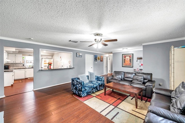 424 Forest Glen Ave, Lakeland, FL 33813 - living room with crown molding, a ceiling fan, dark wood finished floors, a textured ceiling, and baseboards