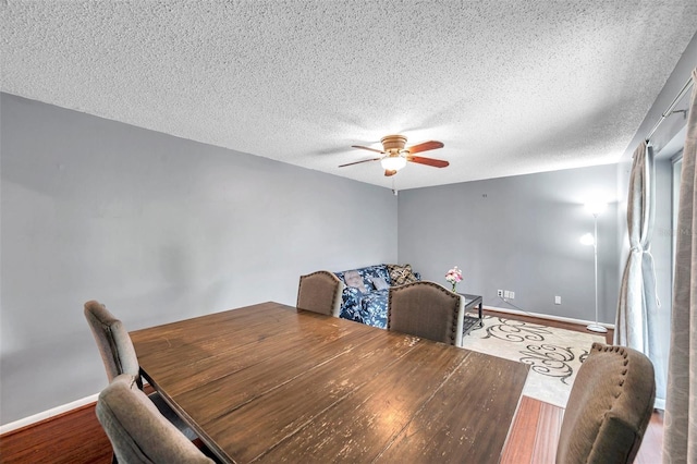424 Forest Glen Ave, Lakeland, FL 33813 - dining space featuring a ceiling fan, wood finished floors, baseboards, and a textured ceiling