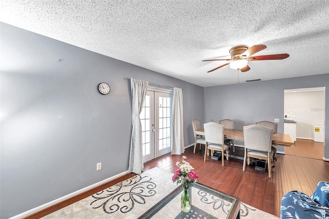 424 Forest Glen Ave, Lakeland, FL 33813 - dining room with wood finished floors, a textured ceiling, a ceiling fan, french doors, and baseboards