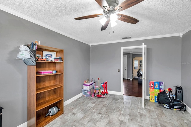 424 Forest Glen Ave, Lakeland, FL 33813 - game room featuring a textured ceiling, wood finished floors, a ceiling fan, crown molding, and baseboards