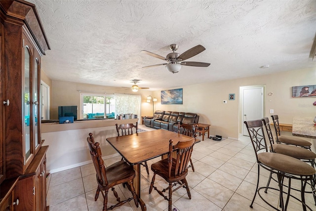 dining room with light tile patterned flooring, ceiling fan, and a textured ceiling
