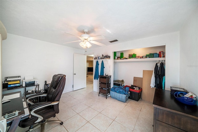 home office with ceiling fan, light tile patterned flooring, and visible vents