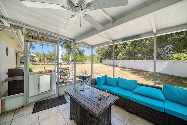sunroom with an outdoor living space, ceiling fan, and beam ceiling