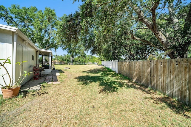 view of yard with a fenced backyard and a patio area