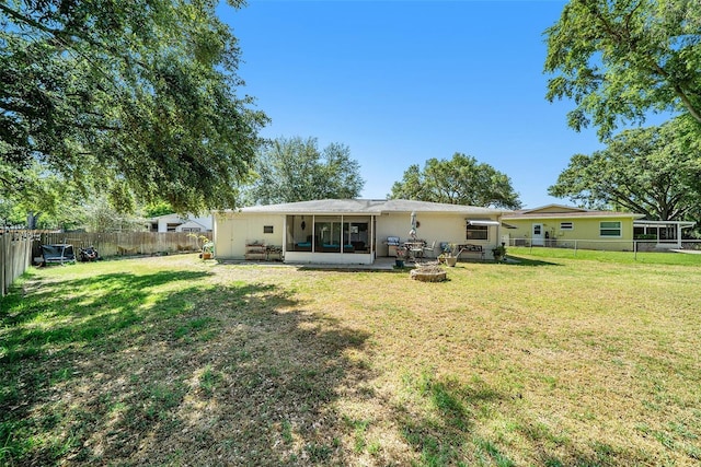 back of house with a yard, a fenced backyard, and a patio area