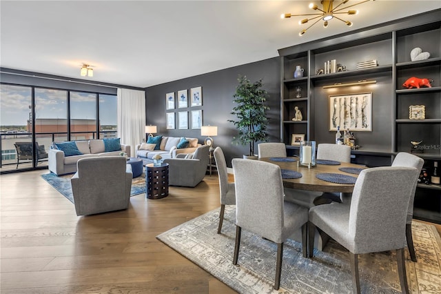 199 Dali Blvd Unit 902, Saint Petersburg, FL 33701 - dining room with wood finished floors, a chandelier, and built in shelves
