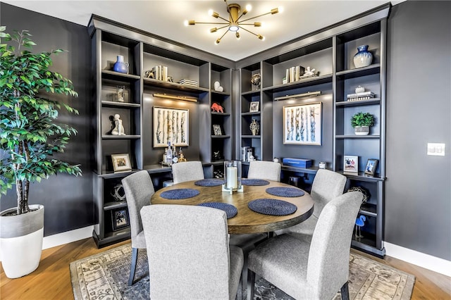 199 Dali Blvd Unit 902, Saint Petersburg, FL 33701 - dining area with wood finished floors, a chandelier, built in shelves, and baseboards