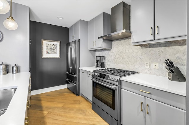 199 Dali Blvd Unit 902, Saint Petersburg, FL 33701 - kitchen featuring appliances with stainless steel finishes, wall chimney range hood, gray cabinetry, and light wood-style flooring