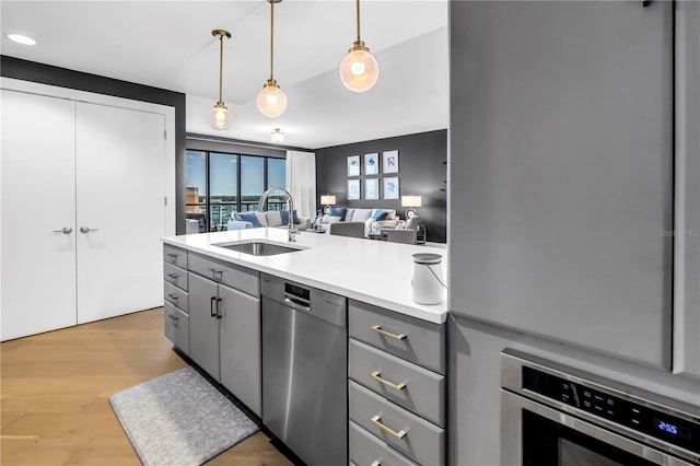199 Dali Blvd Unit 902, Saint Petersburg, FL 33701 - kitchen featuring gray cabinetry, appliances with stainless steel finishes, a sink, and light countertops