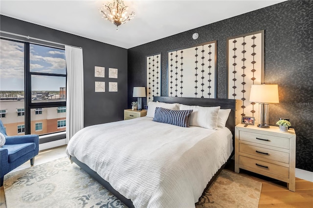 199 Dali Blvd Unit 902, Saint Petersburg, FL 33701 - bedroom with wallpapered walls, wood finished floors, and a chandelier