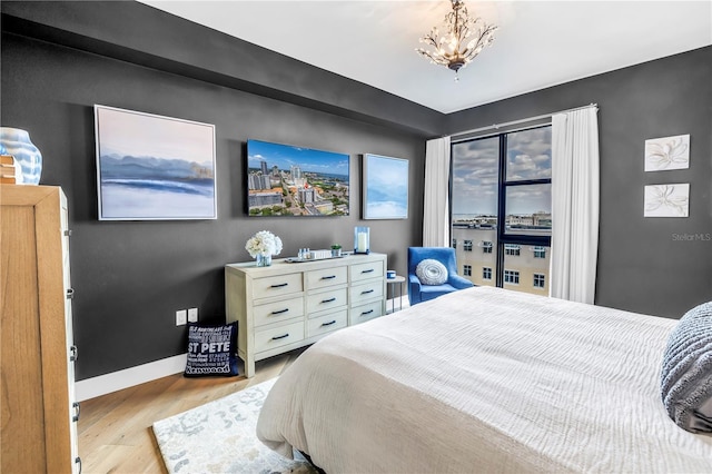 199 Dali Blvd Unit 902, Saint Petersburg, FL 33701 - bedroom with wood finished floors, a chandelier, and baseboards