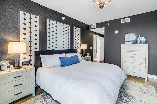199 Dali Blvd Unit 902, Saint Petersburg, FL 33701 - bedroom with wallpapered walls and wood finished floors