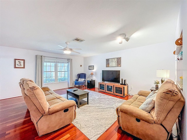 3078 Pointer Dr, Palm Harbor, FL 34683 - living area featuring a textured ceiling, ceiling fan, wood finished floors, and visible vents