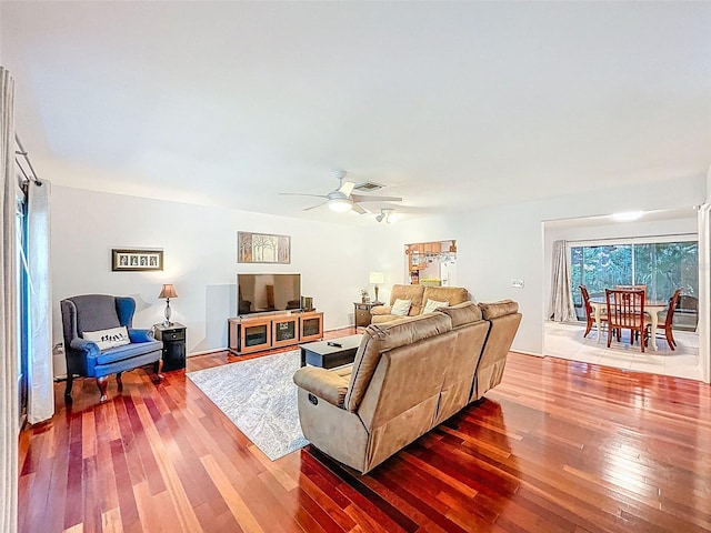 3078 Pointer Dr, Palm Harbor, FL 34683 - living area with wood-type flooring, a ceiling fan, and visible vents