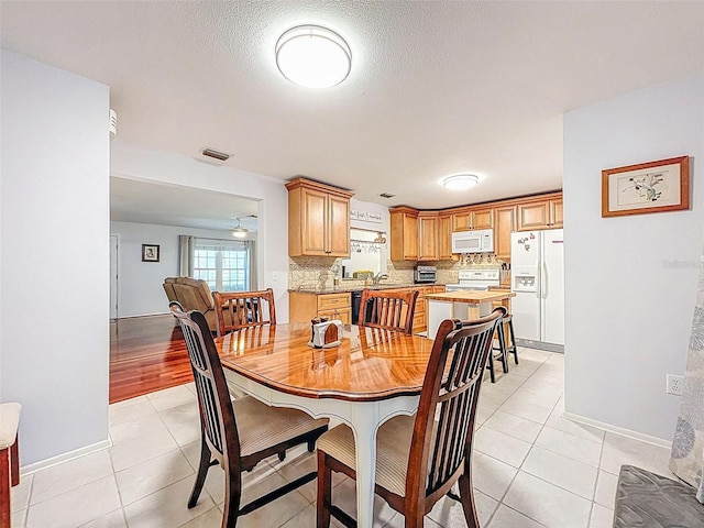 3078 Pointer Dr, Palm Harbor, FL 34683 - dining room with baseboards, visible vents, and light tile patterned floors
