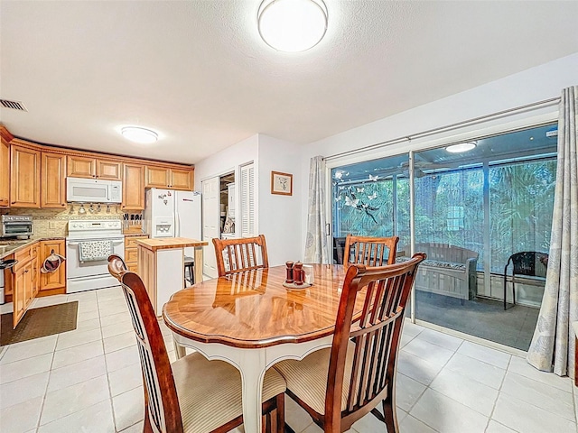 3078 Pointer Dr, Palm Harbor, FL 34683 - dining area featuring light tile patterned floors, a toaster, a textured ceiling, and visible vents
