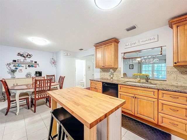 3078 Pointer Dr, Palm Harbor, FL 34683 - kitchen featuring a sink, dishwasher, wooden counters, light tile patterned floors, and visible vents