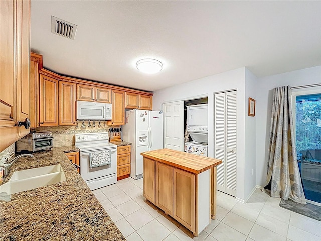 3078 Pointer Dr, Palm Harbor, FL 34683 - kitchen with stacked washer / drying machine, a sink, white appliances, wooden counters, and visible vents