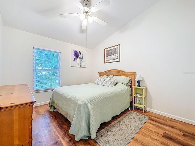 3078 Pointer Dr, Palm Harbor, FL 34683 - bedroom with baseboards, vaulted ceiling, and wood finished floors