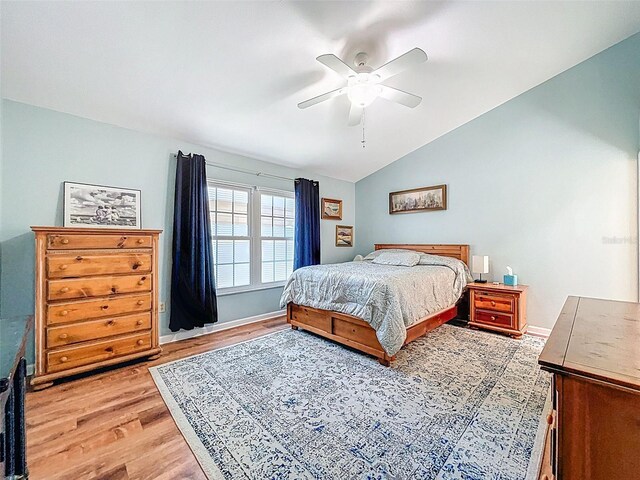3078 Pointer Dr, Palm Harbor, FL 34683 - bedroom featuring a ceiling fan, vaulted ceiling, and light wood-type flooring