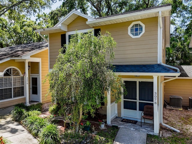 3078 Pointer Dr, Palm Harbor, FL 34683 - view of front of home featuring central AC and roof with shingles