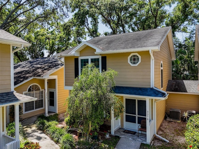 3078 Pointer Dr, Palm Harbor, FL 34683 - rear view of property featuring central air condition unit and roof with shingles