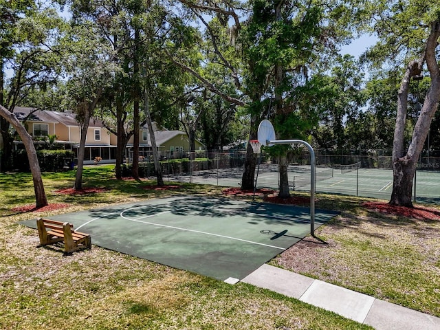 3078 Pointer Dr, Palm Harbor, FL 34683 - view of basketball court featuring fence, community basketball court, a tennis court, and a lawn