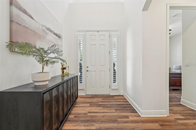 entryway featuring baseboards and wood finished floors