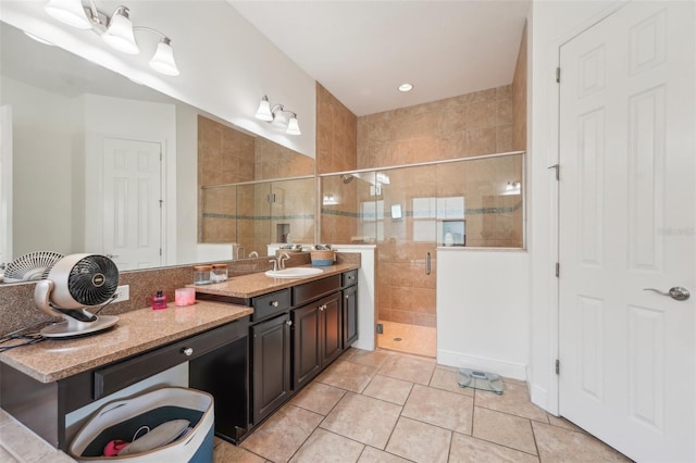 full bath with vanity, tile patterned floors, and a stall shower