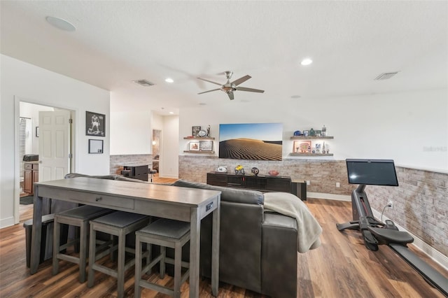 living area featuring a ceiling fan, recessed lighting, wood finished floors, and visible vents