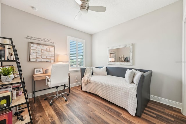 office space with a ceiling fan, baseboards, and wood finished floors