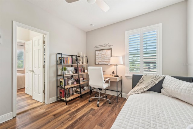bedroom featuring a ceiling fan, baseboards, and wood finished floors