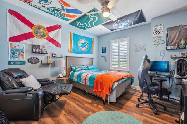 bedroom featuring a ceiling fan and wood finished floors