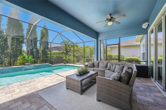 pool featuring an outdoor hangout area, a patio, ceiling fan, and a lanai