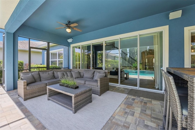 sunroom with ceiling fan and outdoor lounge area