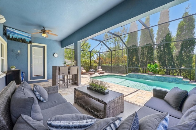 pool with an outdoor living space, ceiling fan, a patio area, and outdoor dry bar