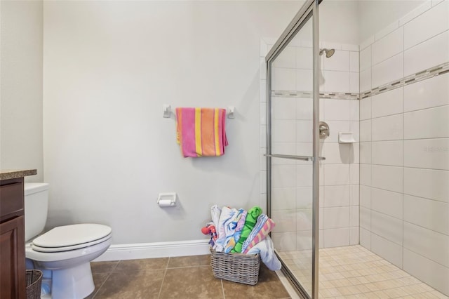 full bathroom with vanity, toilet, tile patterned floors, baseboards, and a stall shower