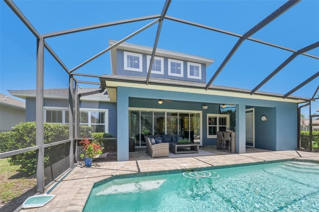 back of property with a patio, an outdoor living space, and stucco siding