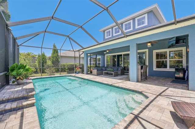 outdoor pool featuring a ceiling fan, a lanai, a patio area, and outdoor lounge area