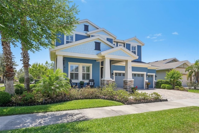 view of front of property featuring an attached garage, a front lawn, and driveway