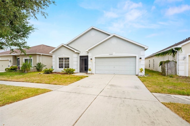 ranch-style house with a garage, stucco siding, and a front lawn