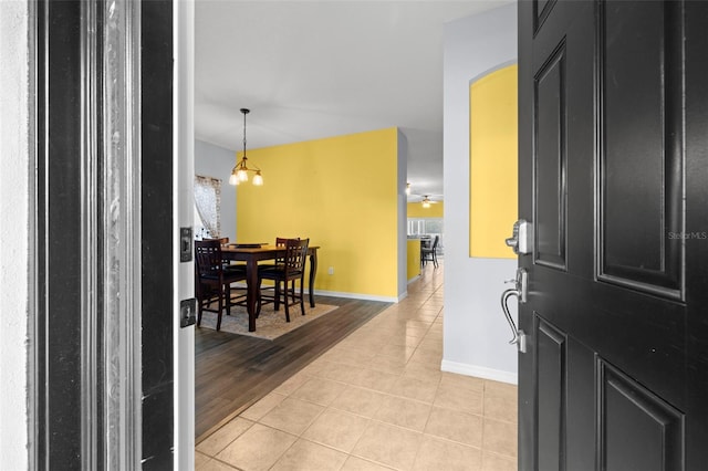 foyer entrance featuring baseboards and light tile patterned flooring