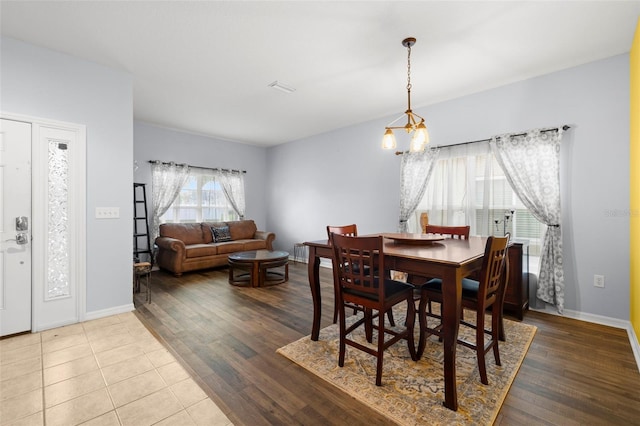 dining area with baseboards, wood finished floors, and visible vents