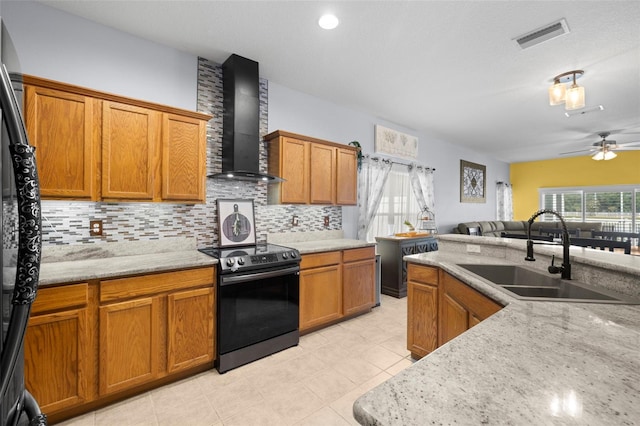 kitchen featuring wall chimney range hood, decorative backsplash, a ceiling fan, electric range, and a sink