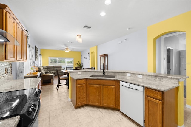 kitchen featuring white dishwasher, ceiling fan, a sink, open floor plan, and black range with electric stovetop