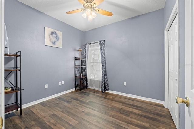 unfurnished bedroom featuring baseboards, ceiling fan, and wood finished floors